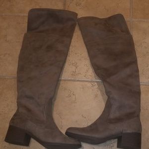 Tan thigh high boots.